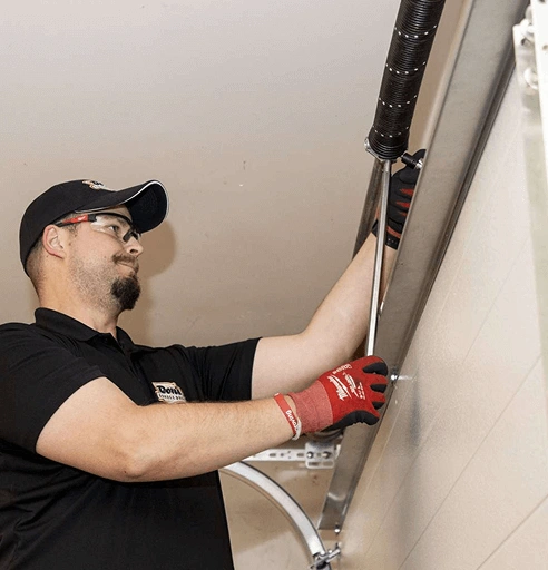 Garage door technician inspecting a garage door